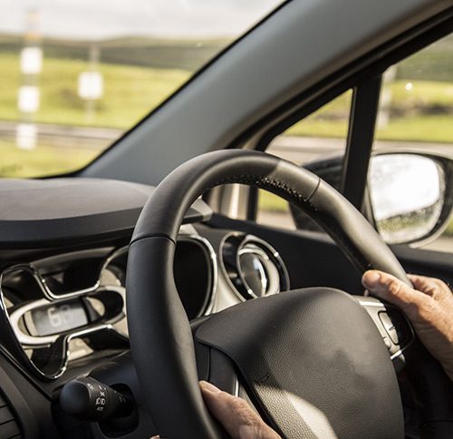 Hands on a steering wheel