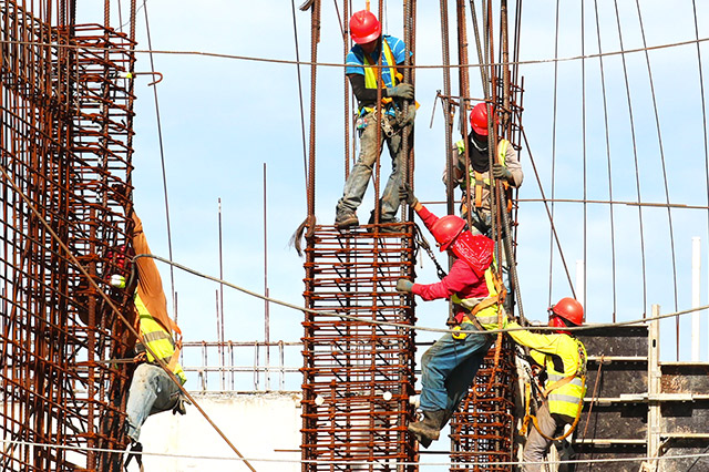 Workers climbing at a job site