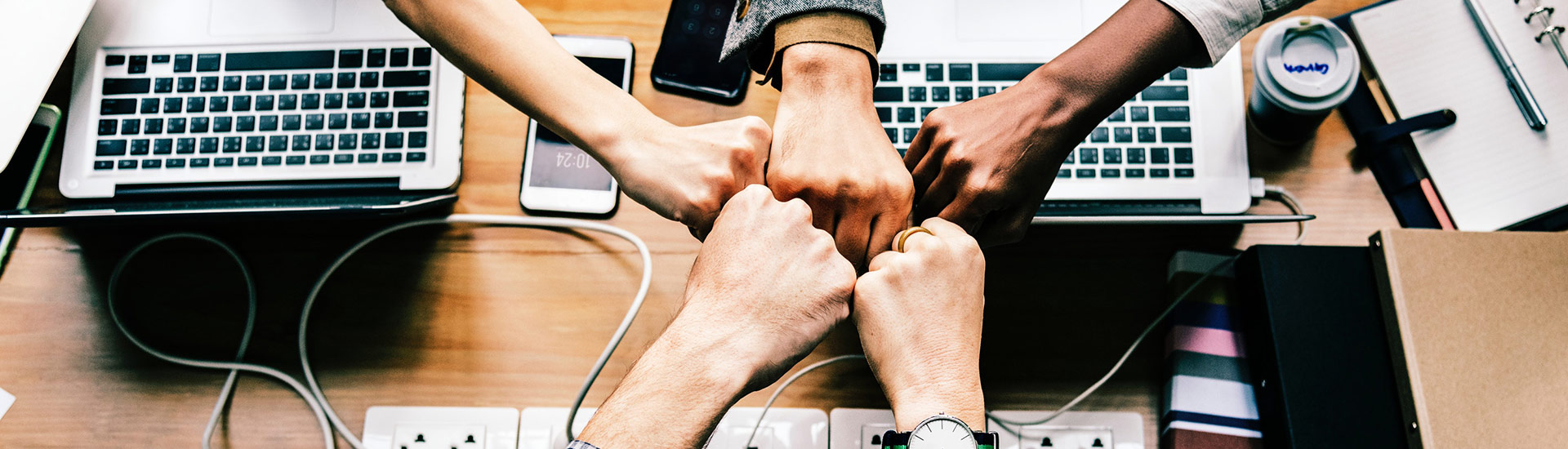 Team members putting their hands together